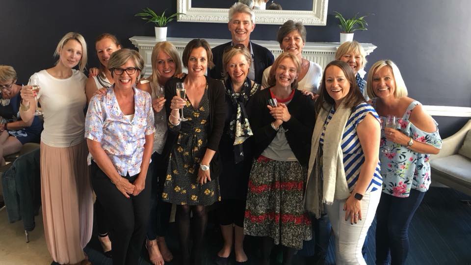 A photo taken in 2018 of a coach training cohort celebrating the end of their training course.